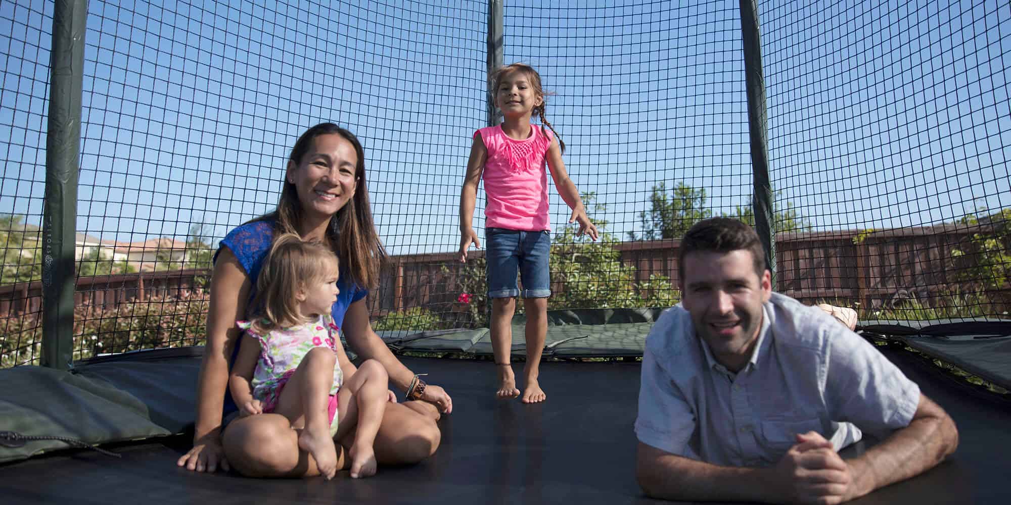 Family sitting on a trampoline