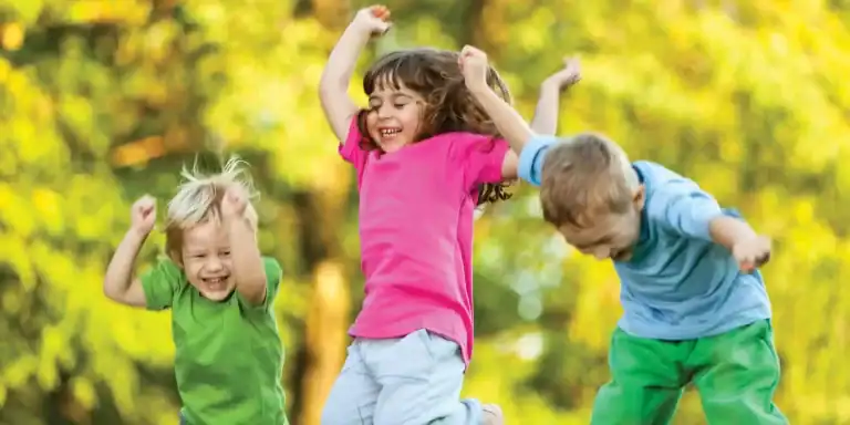 Backyard fall activities for kids: kids jumping in the air